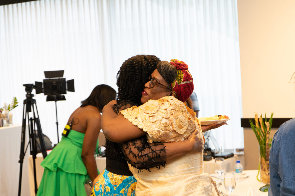 Image of a diverse group of women chatting and exchanging business cards at a Kelisha Mills networking event